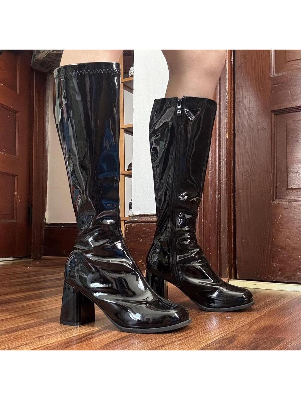 Black knee-high/go go boots with a 4” heel